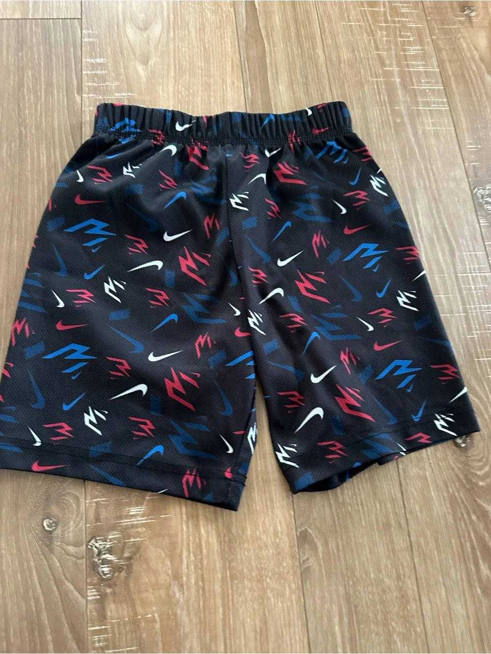 Nike Black Kids Athletic Shorts with Red, Blue & White Swoosh Print
